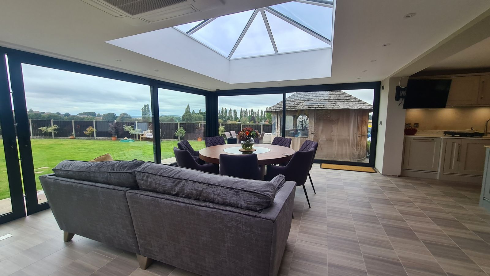 Orangery interior with lantern roof and bi-fold doors